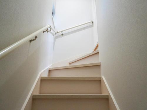 a stairway with a handrail and stairs in a house at OUCHI HOTEL Onaganishi in Hiroshima