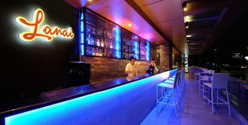 a bar with a man standing at a bar at Golden Prince Hotel & Suites in Cebu City
