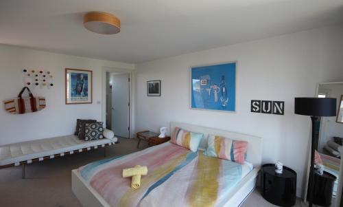 a bedroom with a bed with a cross on it at Eco Friendly beach house in Camber