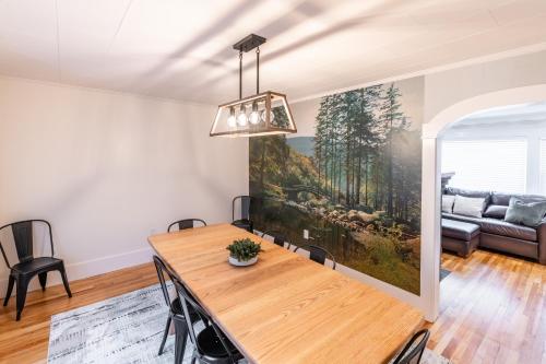 a dining room with a table and a couch at White Mountain Escape in Littleton