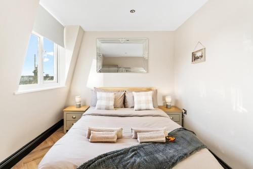 a bedroom with two beds and a mirror at Sea Breeze Escape in Brighton & Hove