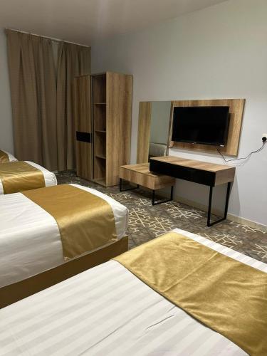 a hotel room with two beds and a piano at فندق نسمات in Al Madinah