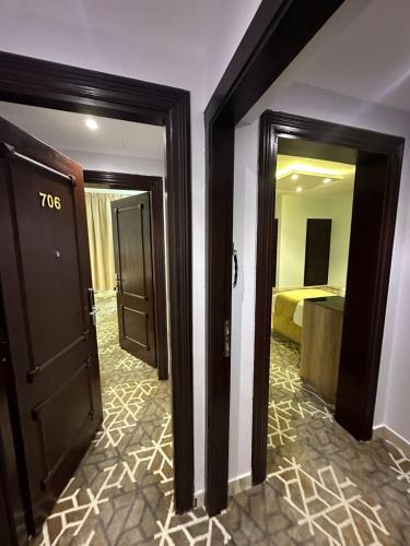 a hotel room with two doors and a bedroom at فندق نسمات in Al Madinah