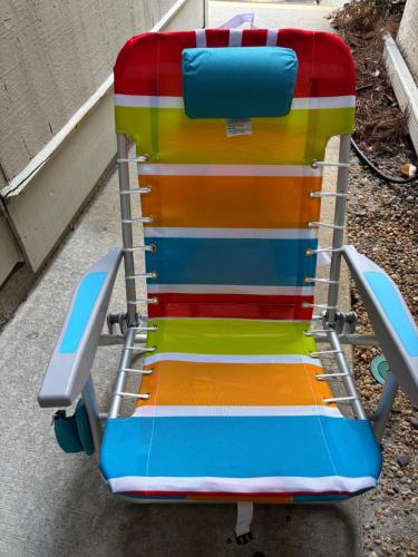 a colorful beach chair sitting on a sidewalk at 13 Beach Stop Hilton Head in Hilton Head Island