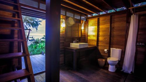 a bathroom with a sink and a toilet and a window at Castaway Resort Koh Lipe in Ko Lipe