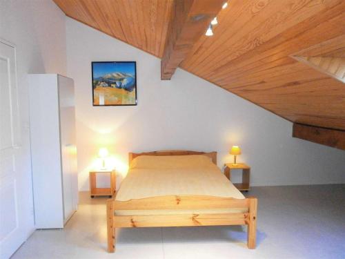 a bedroom with a bed and two lights on two tables at Duplex T3 au cœur de Saint-Lary-Soulan - 6 pers., balcon, parking, skis - FR-1-457-130 in Saint-Lary-Soulan