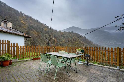 a table and chairs on a patio with a view at Carbayu Senda del Oso in Proaza
