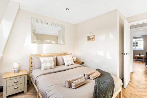 a bedroom with a large bed with two pillows on it at Sea Breeze Escape in Brighton & Hove