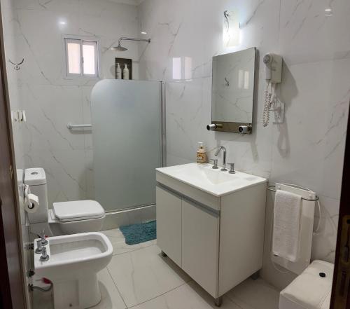 a white bathroom with a sink and a toilet at Like at Home Ezeiza in Ezeiza