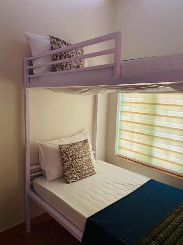 a bedroom with a bunk bed with pillows on it at VILLA CALATHEA Varkala in Varkala