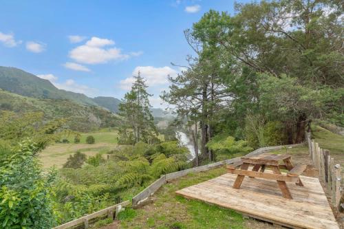 a picnic table with a view of a valley at River Valley Escapes in Thames