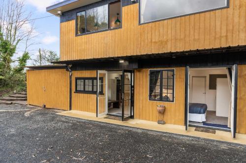 a house with glass doors on the side of it at River Valley Escapes in Thames