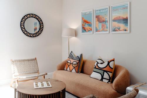a living room with a couch and a table at Dixon House in De Waterkant by Cape Finest in Cape Town