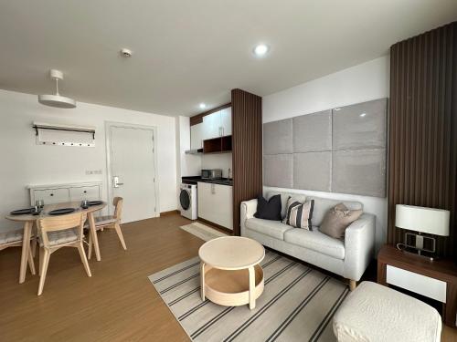 a living room with a couch and a table at 6th Avenue Sukhumvit BKK 302 BTS Asoke & Nana MRT Sukhumvit in Bangkok