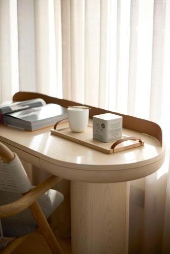 a table with a plate and a box on it at Dusit Suites Hotel Athens in Athens