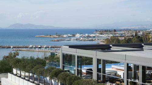 a building with a view of a body of water at Dusit Suites Hotel Athens in Athens