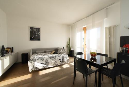 a bedroom with a bed and a table and chairs at LA TERRAZZA VISTA DUOMO, piscina e campi da tennis in Milan