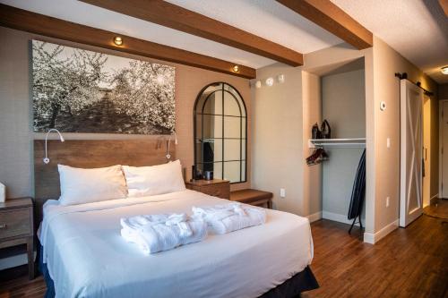 a bedroom with a bed with two towels on it at Old Orchard Inn in Wolfville