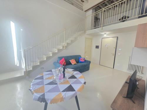 a living room with a table and a couch at Fabroniana apartment Elegant in Pistoia