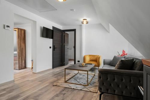 a living room with a couch and a table at SEVEN Apartments in Predeal