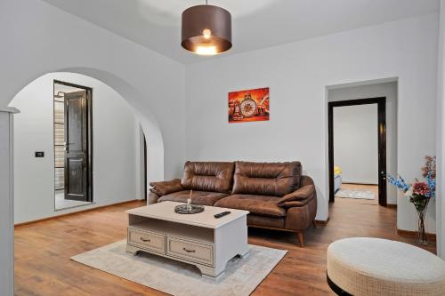 a living room with a couch and a coffee table at SEVEN Apartments in Predeal