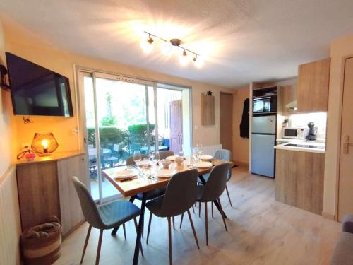 une cuisine et une salle à manger avec une table et des chaises dans l'établissement Appartement T3 pour 6 à Vignec avec terrasse, parking et casier à skis - FR-1-457-346, à Vignec
