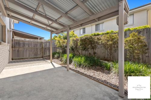 a pergola over a driveway in a home with a fence at Serenity Stay Brisbane in North Lakes