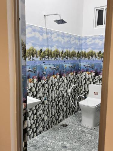 a bathroom with a wall mural of a rock wall at sun mount adams peak in Adams Peak