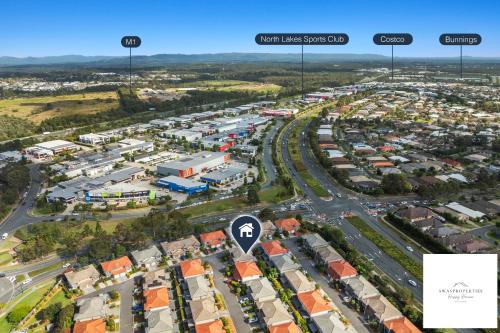 an aerial view of a city with buildings and roads at Serenity Stay Brisbane in North Lakes