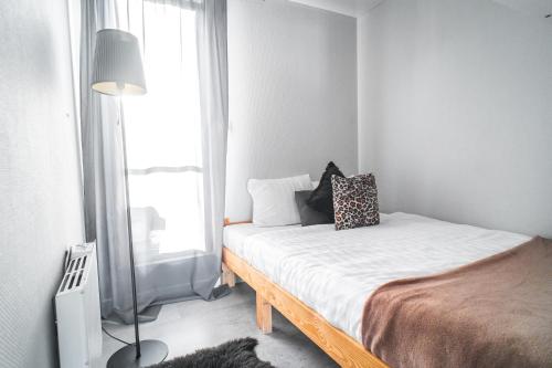 a bedroom with a bed and a window at Cozy houseboat near Giethoorn in Zwartsluis