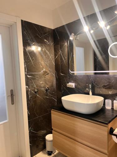 a bathroom with a sink and a mirror at TK OCEANVIEW Apartment in Puerto del Carmen