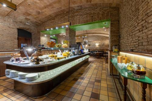 a restaurant with a counter with plates on it at Hotel Rialto in Barcelona