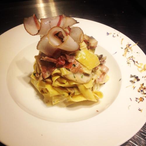 a plate of pasta with shrimp and onions on it at Porto Marine Hotel in Platamonas