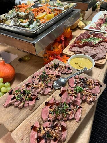 a buffet with many different types of food on display at L'Hôtel et Restaurant du Golf de Clervaux in Eselborn