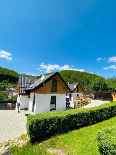a house with a white and brown house at CHALETY MÝTO POD ĎUMBIEROM in Mýto pod Ďumbierom
