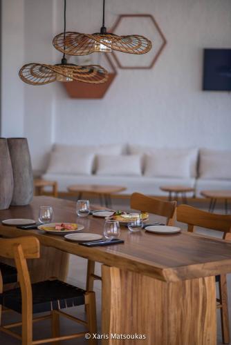 a dining room with a wooden table and chairs at Ilios Suites in Kato Gouves