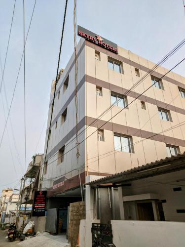 a building with a sign on the side of it at Skyry Hotels Singanallur in Coimbatore