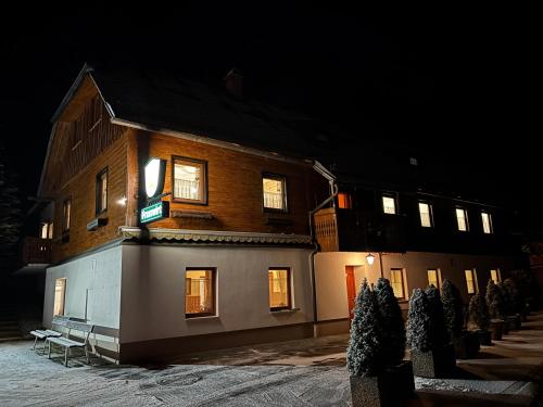 a building with a sign on the side of it at night at Gasthof Frasswirt in Frass