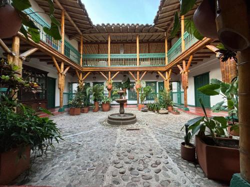 a courtyard with a fountain and potted plants at Hacienda Bambusa in El Caimo