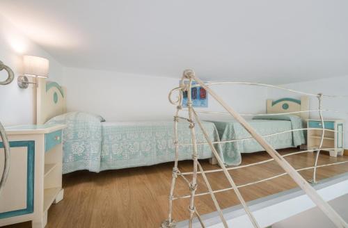 a bedroom with a bunk bed and a ladder at Bosa Queen House in Bosa