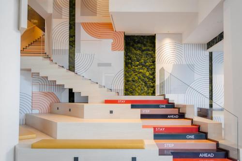 a stairwell with colourful steps and a wall at EVEN Hotel Shanghai Hongqiao CBD by IHG in Shanghai