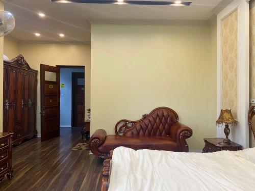 a bedroom with a bed and a couch in a room at Mây Homestay in Cao Bằng in Cao Bằng