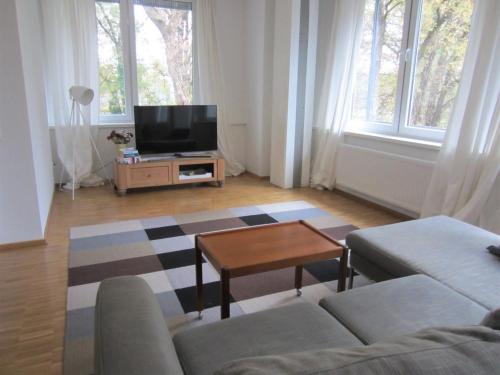 a living room with a couch and a tv at K9 Wohnungen in Münster