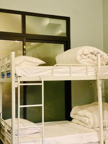two bunk beds in a room with a mirror at Mây Homestay in Cao Bằng in Cao Bằng