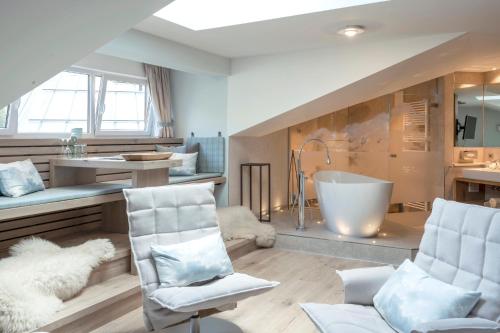 a bathroom with a sink and a bath tub at Berghotel Schlossanger Alp in Pfronten