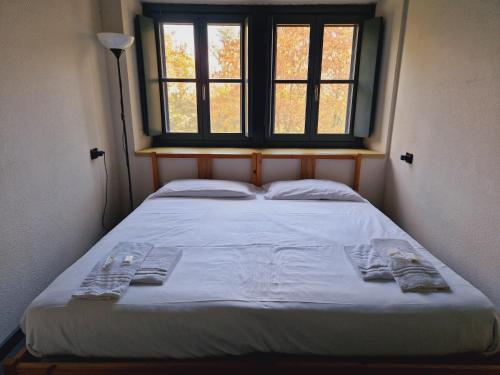 a bed in a small room with a window at B&B e Ostello, Parco di Monza, CASCINA COSTA ALTA in Monza