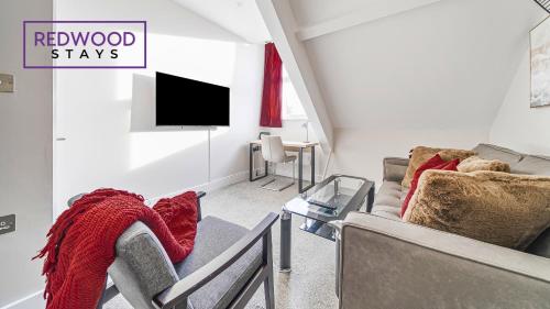 a living room with two couches and a tv at Newly Refurbished Everest Lodge Serviced Apartments for Contractors & Families, FREE WiFi & Netflix by REDWOOD STAYS in Farnborough