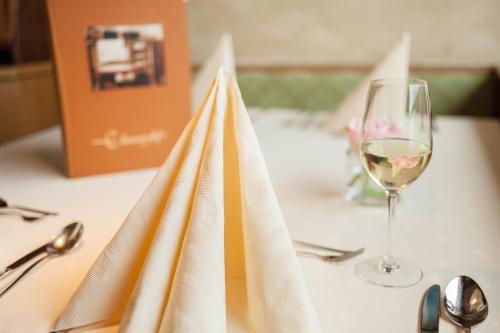 a table with a glass of wine and a napkin at Gasthof Ellmauer Hof in Ellmau