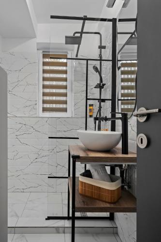 a bathroom with a sink on a wooden table at SEVEN Apartments in Predeal