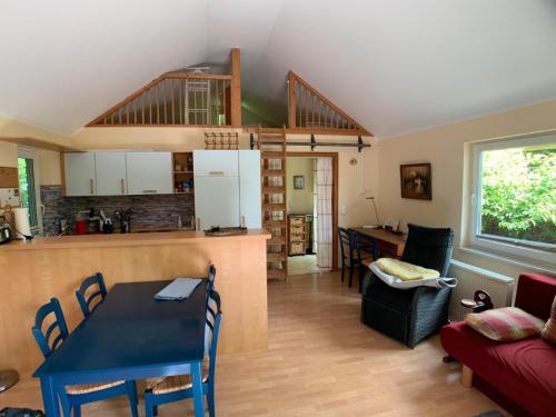 a kitchen and a living room with a table and a dining room at Ferienhaus Loubier Marne in Marne